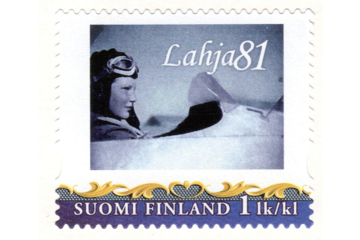 Postimerkissä nainen ohjaamassa purjelentokonetta, yllä teksti Lahja 81.
