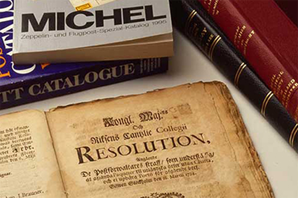 Books in stacks, old book open.