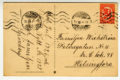 Postikortin tausta, jossa on punainen Vaasan malli 1918 -postimerkki Helsingin postileimoilla, sivuttain kirjoitettu joulutoivotus ja osoite-kohdassa Familjen Wickströmin osoite Helsinforsiin.